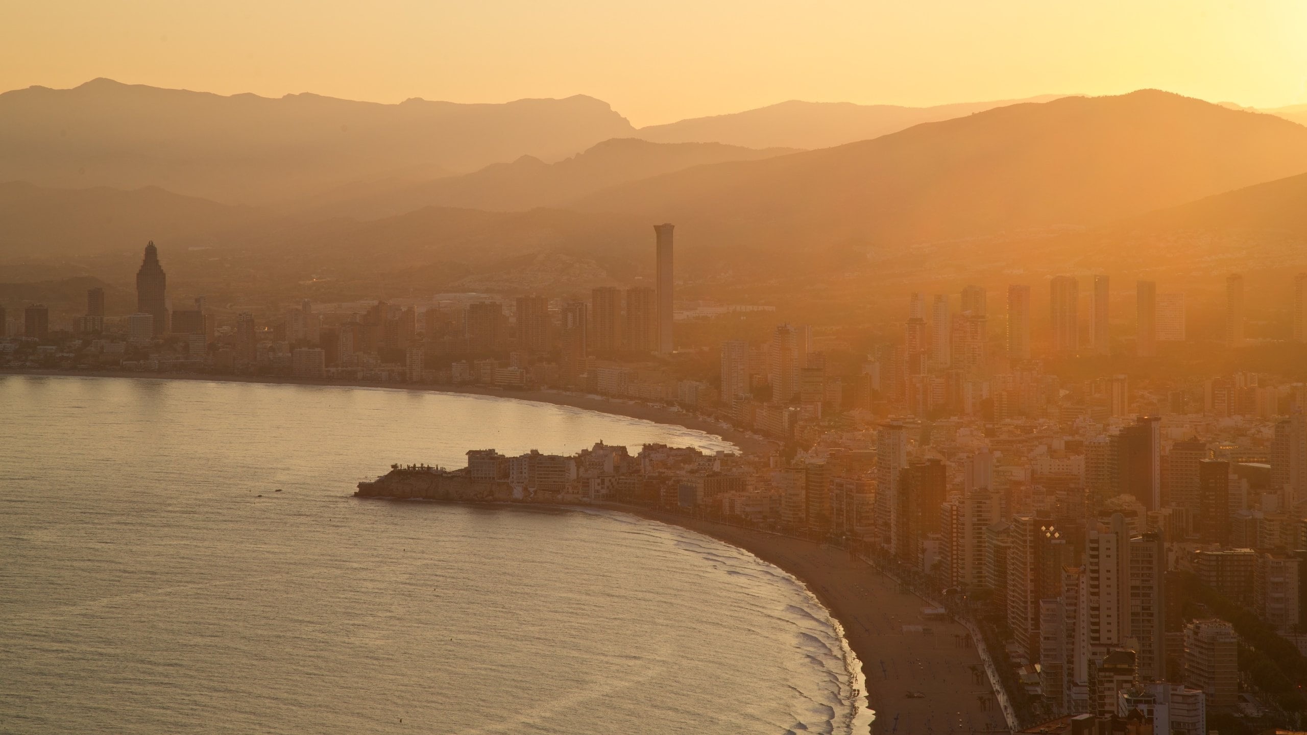 Family taking a photo at sunset in Benidorm